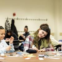 Girls of Color Summit previous event and three girls doing an activity